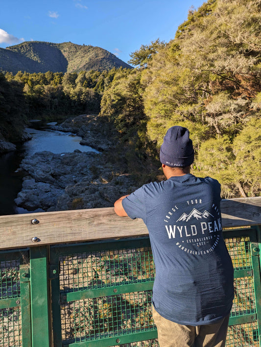 Guy wearing organic cotton tee tshirt overlooking a trail in the USA