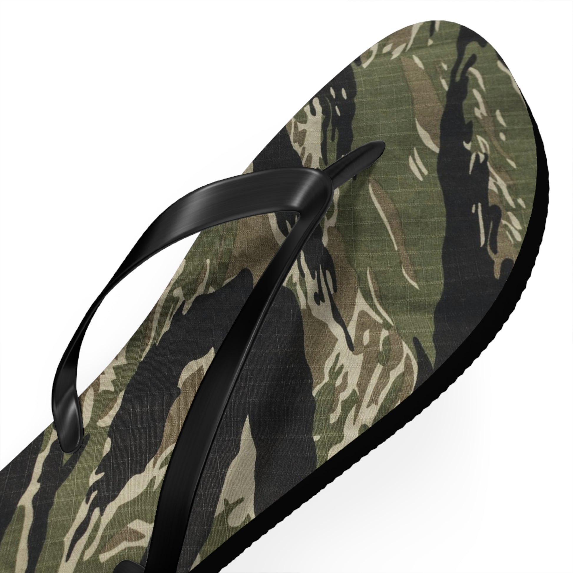 a pair of camouflage flip flops on a white background