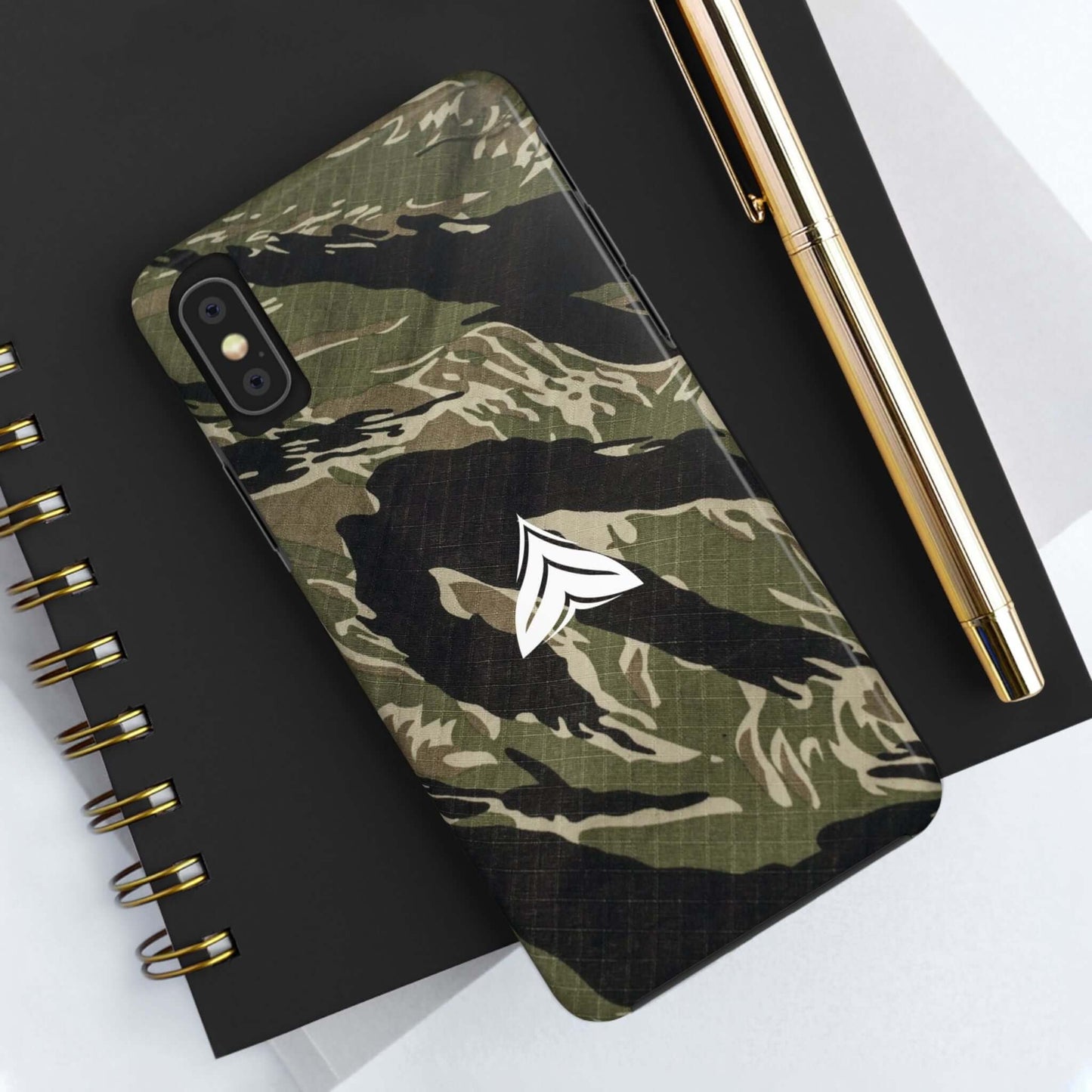 Tough camo phone case on notepad, stylish rugged design, USA product, compatible with iPhone and Samsung.